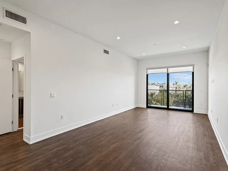 Large-Size Bedroom with Recessed Lighting, Vinyl Flooring, and Balcony Access