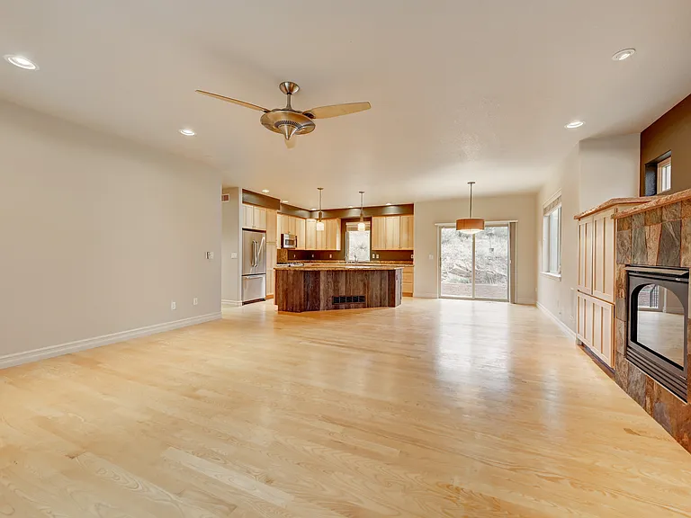 Living room open to dining area and kitchen prior to furnishing