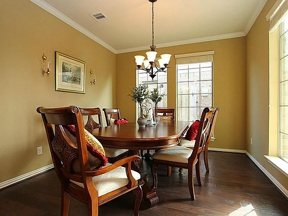 Formal dining room with light fixture and wood floods