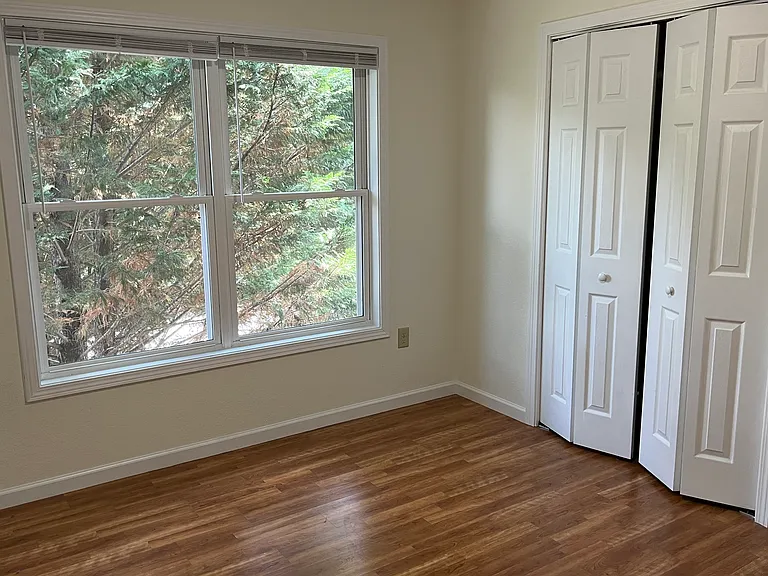 Bedroom to left has leland cypress tree view (many tenants who work night hours have been very pleased with this darker bedroom)