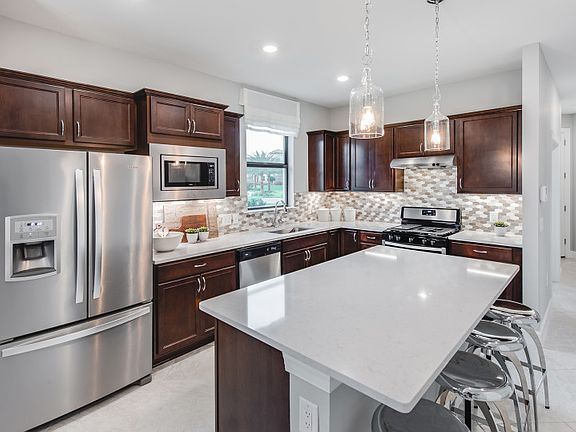 Kitchen with large center island and stainless steel appliances