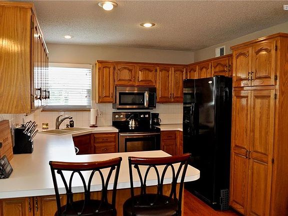 Tons of cabinets including a pantry and hardwood floors