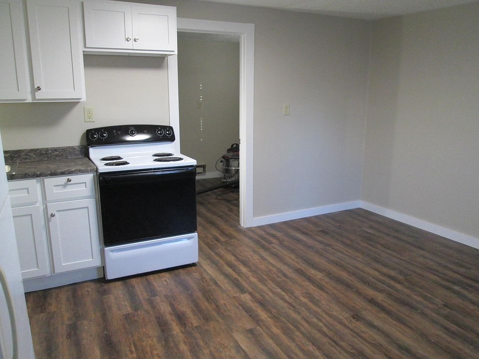 Standing in the living room looking into the bedroom (right) and kitchen (left).