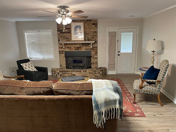 Living room view from fron entry hallway. Door leads to back patio and greenhouse.
