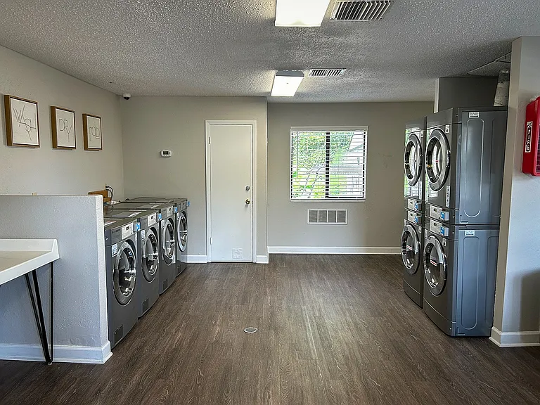 Enjoy the convenience of a well-equipped laundry facility with ample natural light.