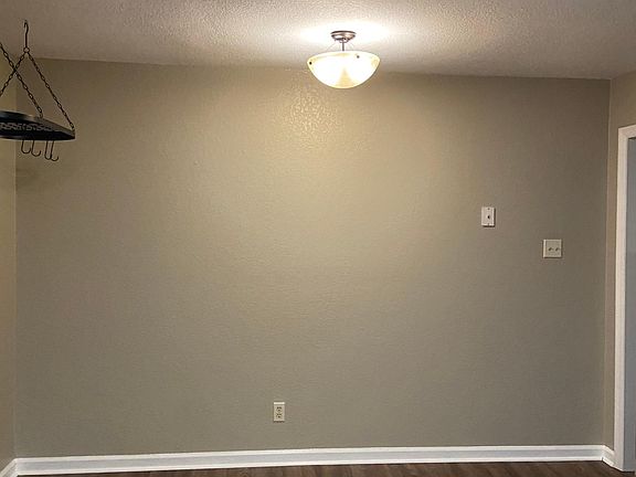 Breakfast nook in kitchen. Hanging pot rack stays.