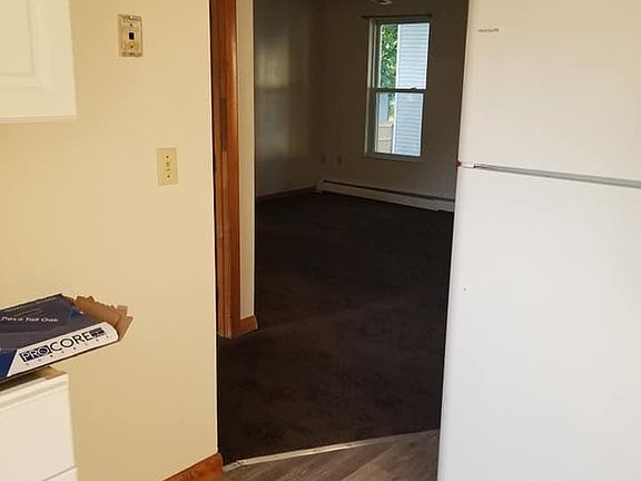 View of kitchen into living area, additional countertop/cabinet (to left in kitchen), great for coffee station or additional storage!
