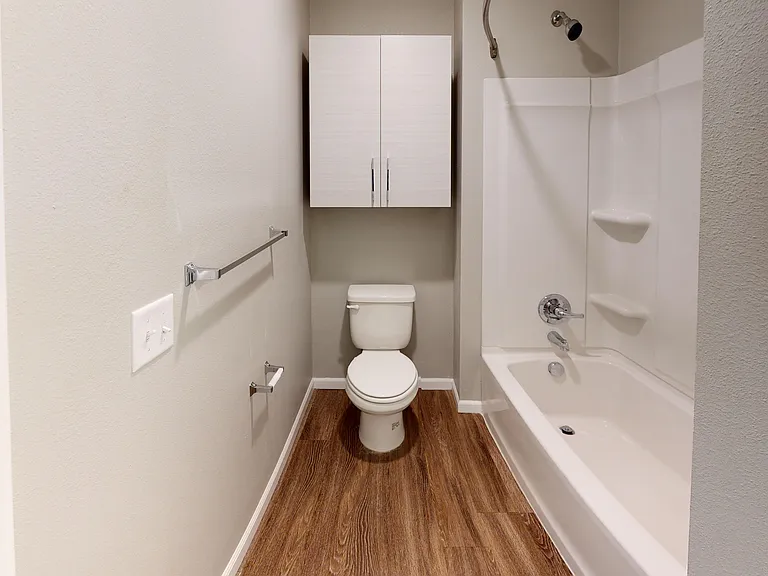 The other bathroom of The Walnut floor plan includes a bathtub and shower. The other bathroom of The Walnut floor plan includes a bathtub and shower.