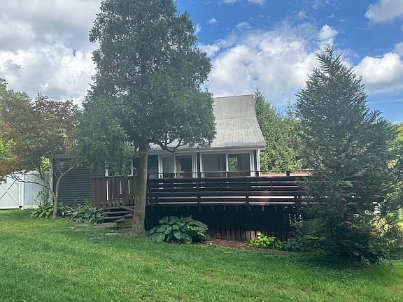 L-shaped deck and backyard with entry