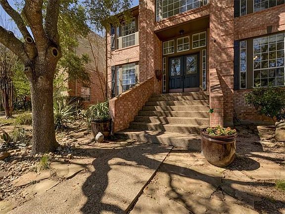 Up to date landscaping and stone walkways frame the double door entrance.