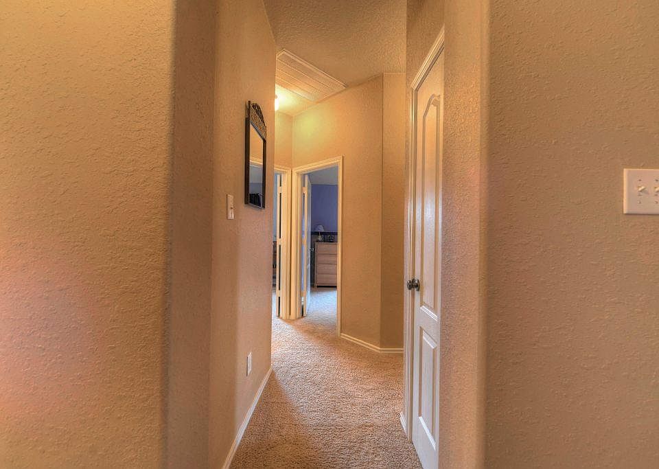 Hallway to secondary bedrooms. Secondary bedrooms are separated from master bedroom which allows for great privacy.