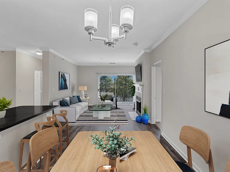 A modern dining room with a wooden table and chairs.