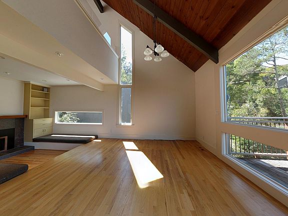 Living room with adjacent conversation area, back deck - per