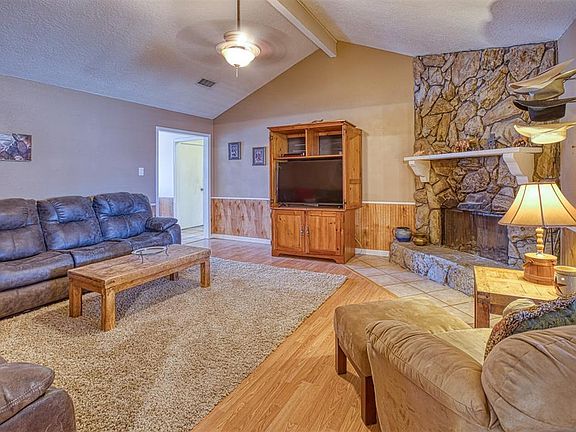 Alternate view of living room show casing the wood burning fire place