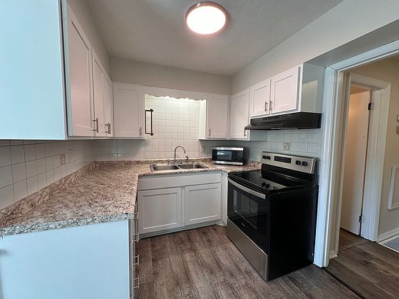 Kitchen - microwave, dishwasher, stove, and fridge.