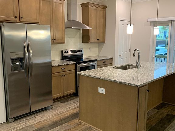 Look at this brand new kitchen with refrigerator and balcony outside the patio doors