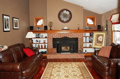Family room has gorgeous Brazilian hardwoods, fireplace w/woodburning insert