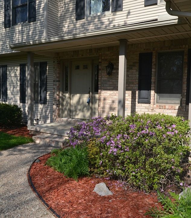 An inviting walkway leads up to the main entrance of the home.  The landscaping has already been installed and adds great urb appeal to the home.