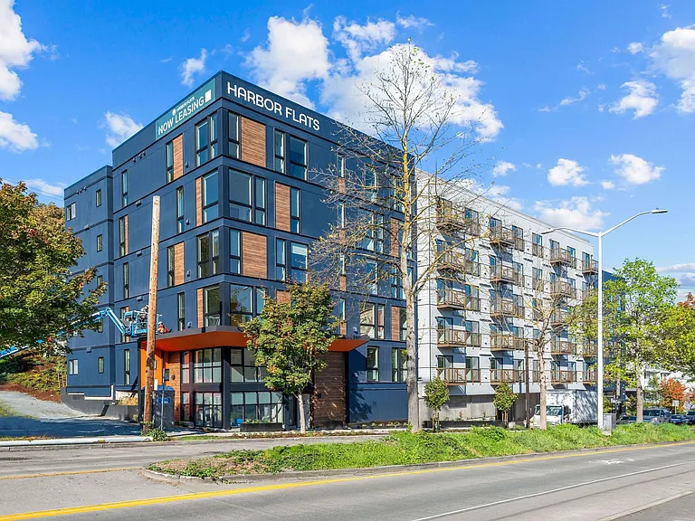 The exterior view of Harbor Flats showcases its modern design and prime location, offering residents convenient access to city amenities.