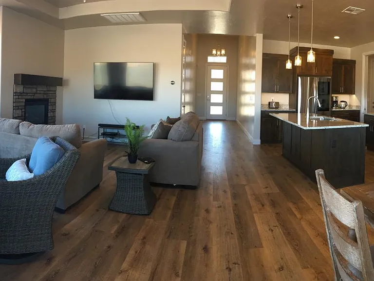 Large open living, dining, kitchen area at back side of home