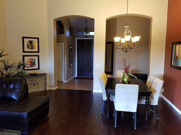Living room and dining room with gorgeous dark wood flooring.