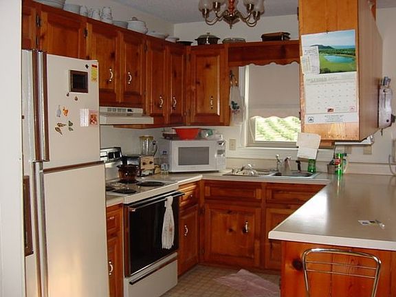 The kitchen and dining area are cozy with lots of cabinet storage.