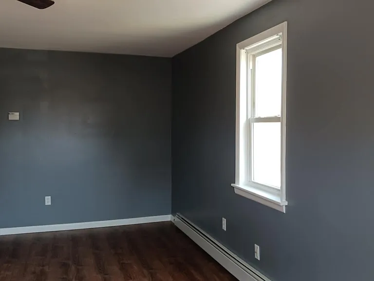 living room facing toward short hallway to kitchen