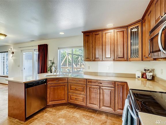 Kitchen has eating space , lots of light and Cabinet Space. Slider is off Kitchen and Family Room opening up to the Cedar Deck.