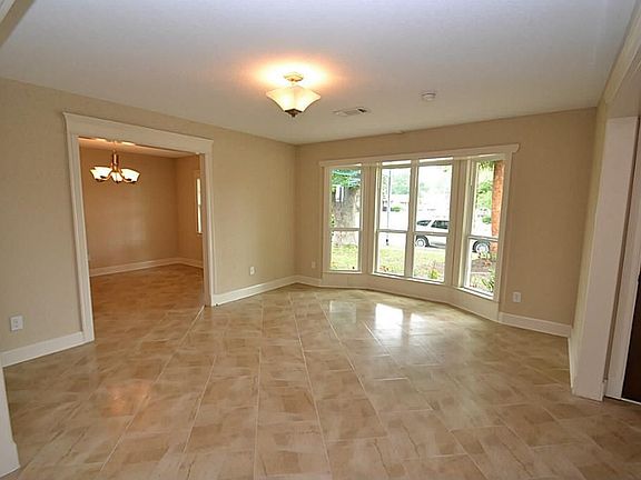 Living accented by tile floors, bay window and opens to the dining room.