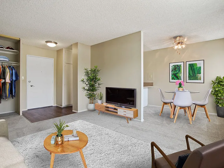 Living room and dining area with carpeted floors throughout
