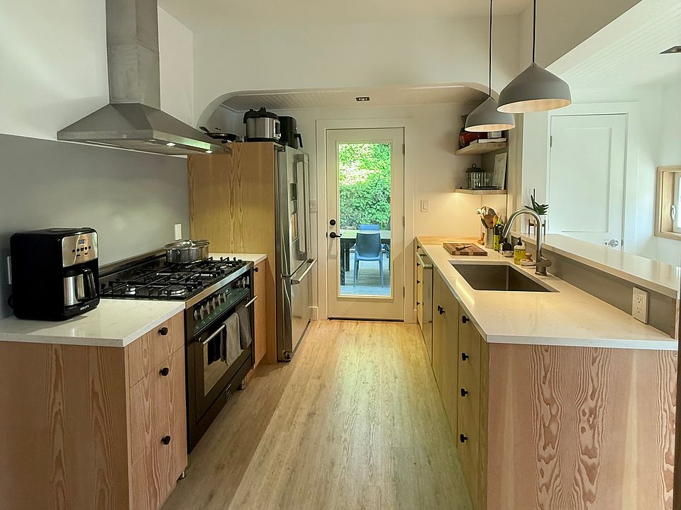 kitchen with exterior door leading to the lower unit deck and backyard