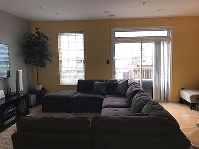 Open floorplan with a view from the kitchen to the living room through the outside deck.