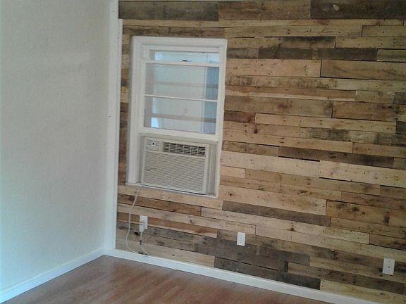 Living room with AC and new floors and new accent wall