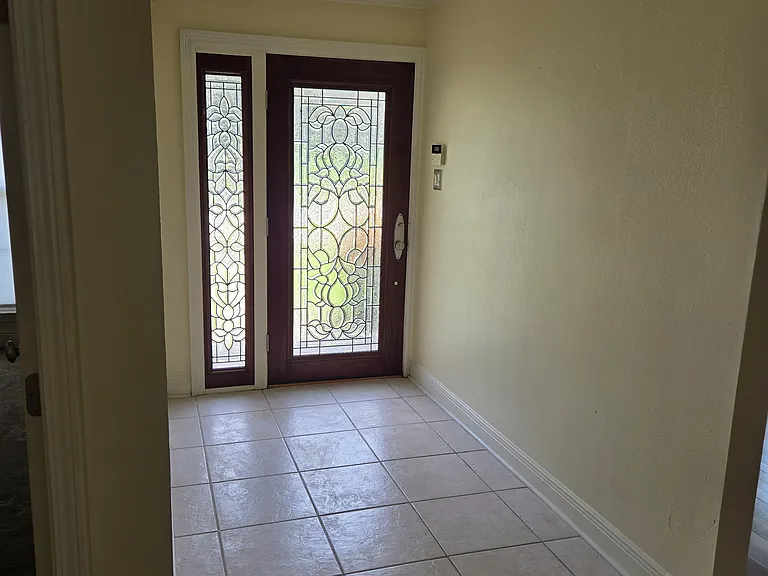 Front foyer with frosted glass side panel and front door.