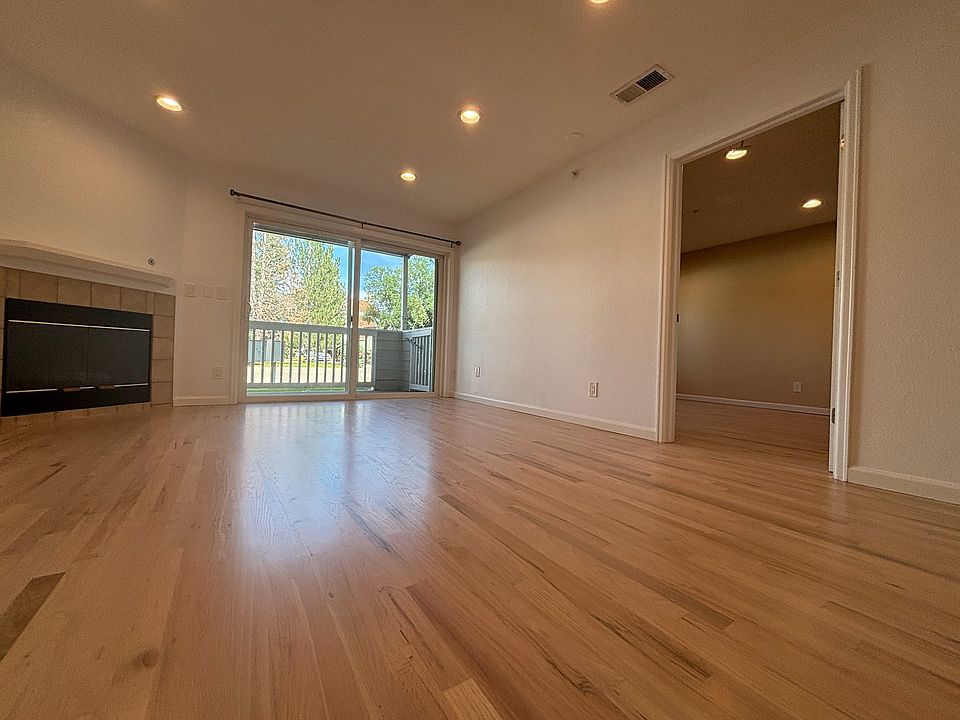 entrance - view of living space, fireplace, balcony, and main bedroom