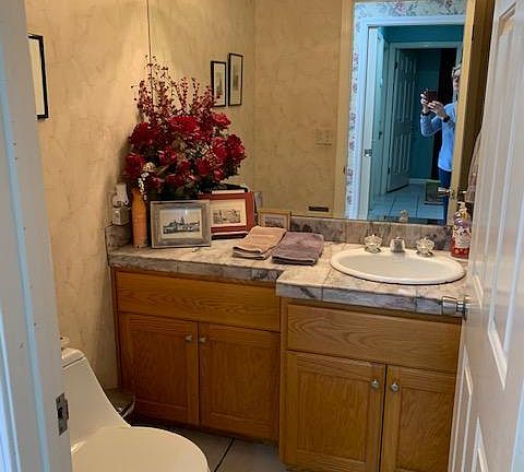 Guest 1/2 bath off of the entryway with marble countertops.