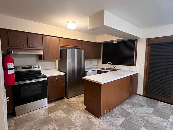 Generous Kitchen with ample Cabinet and counter space, plus stainless steel appliances, including a dishwasher.