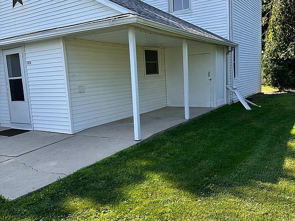 Back door and side porch with storage shed
