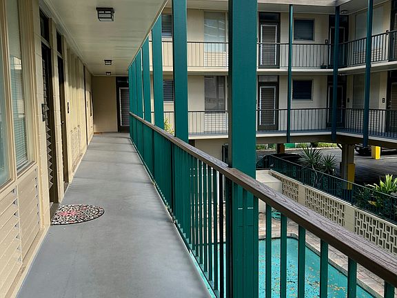 Second floor walk-up around pool/courtyard.