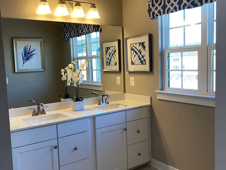 Double Sink Vanity with Granite Counter-Top and White Cabinets in the Primary Bathroom #1