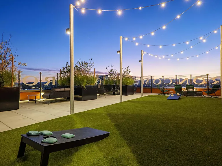Hang out at the rooftop lounge, complete with cornhole and festive lighting for a fun evening.