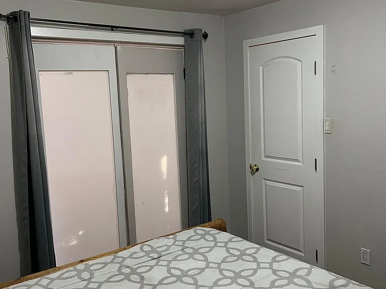 Insid bedroom 1 with closet and tinted door.