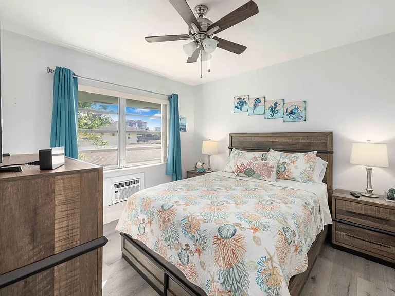 The second bedroom has a queen size bed, a personal AC unit, and smart TV.