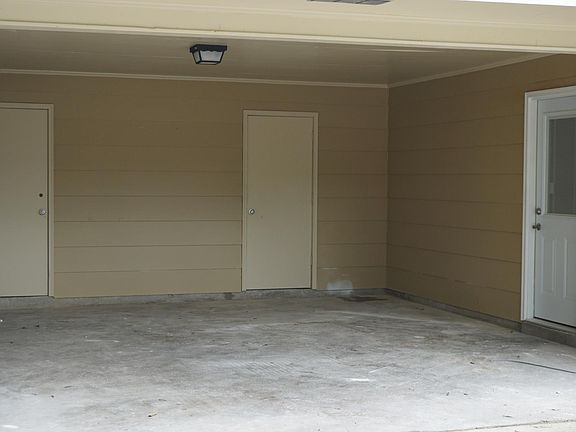 Covered Carport with storage sheds