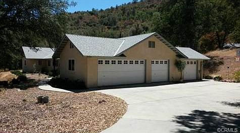 Notice concrete drive leading up to garages