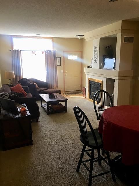 Living room and dining area with fireplace