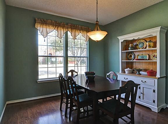 Lovely Formal Dining Room has Designer Lighting. A Great Spot to Relax with Family or Friends!