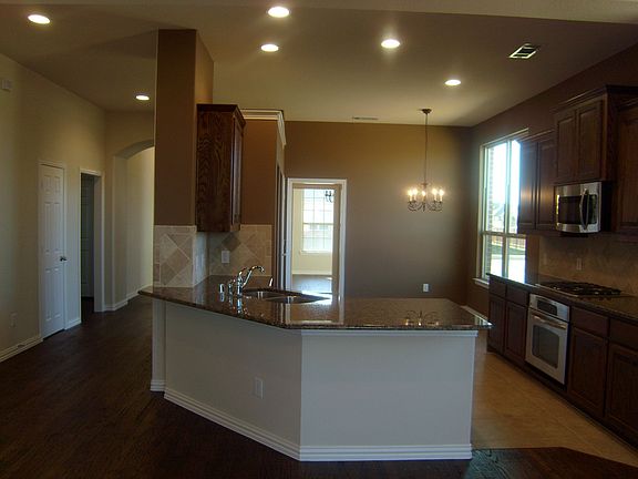Wonderful kitchen equipped with custom cabinets and a gas cook-top.