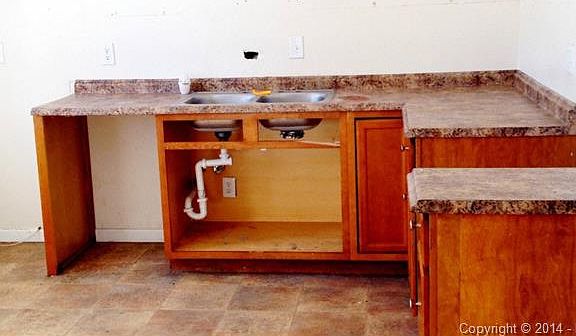 Kitchen is missing all appliances and cabinets