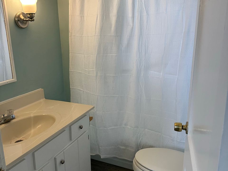 Bathroom with vanity, toilet and traditional shower.